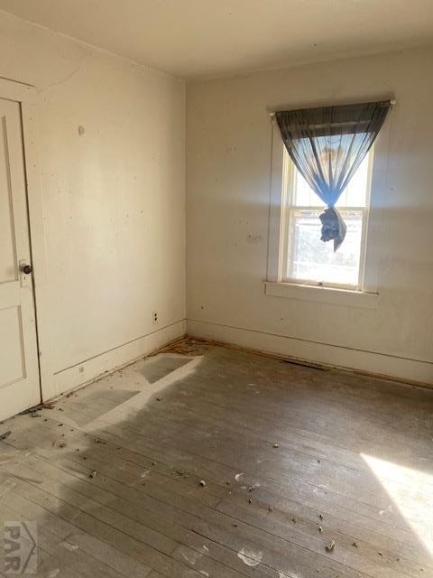 unfurnished room featuring hardwood / wood-style floors