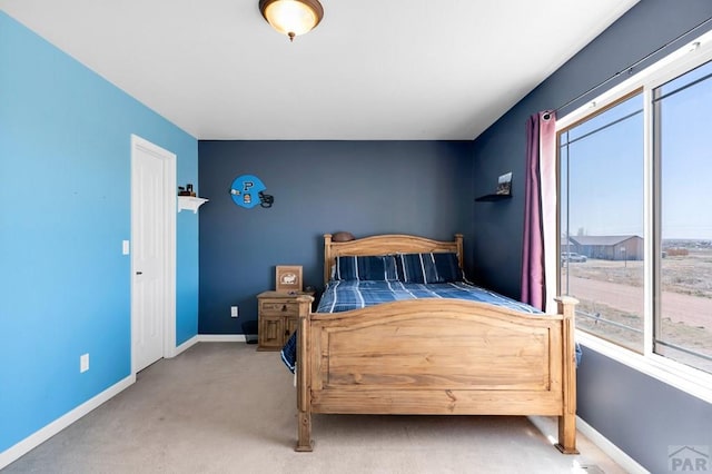 bedroom with baseboards and carpet floors