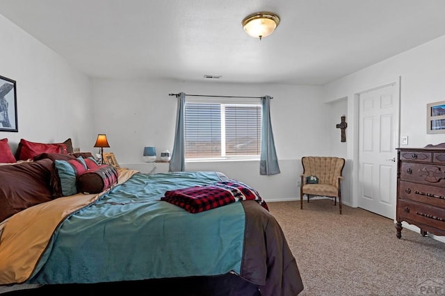 carpeted bedroom featuring visible vents