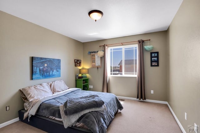bedroom featuring baseboards and light colored carpet
