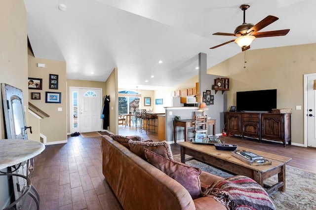 living room featuring a ceiling fan, wood finished floors, baseboards, lofted ceiling, and recessed lighting