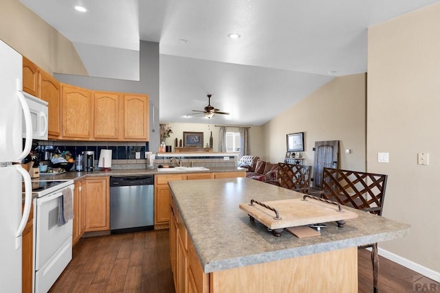kitchen featuring vaulted ceiling, dark wood-style flooring, a sink, and white appliances