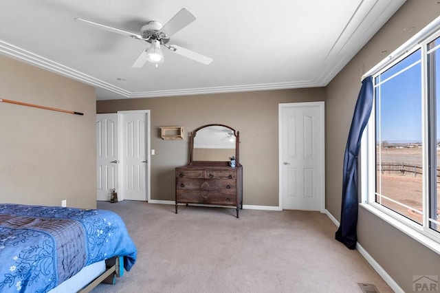 bedroom featuring light carpet, a ceiling fan, and baseboards