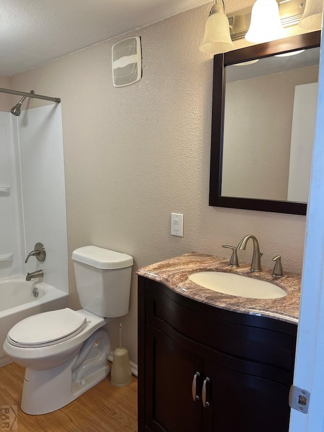 bathroom featuring shower / tub combination, wood finished floors, toilet, and vanity