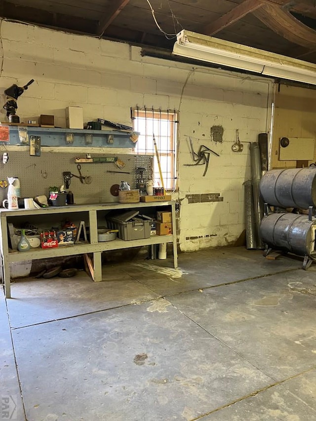 below grade area with concrete block wall and a workshop area