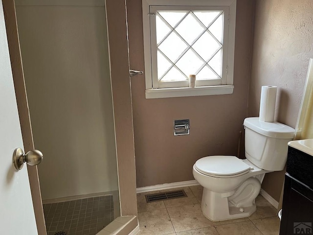 bathroom featuring vanity, tile patterned floors, toilet, visible vents, and baseboards