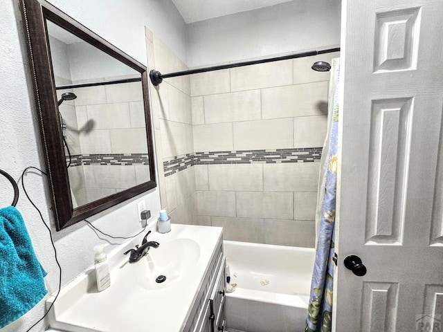 bathroom featuring shower / tub combo and vanity