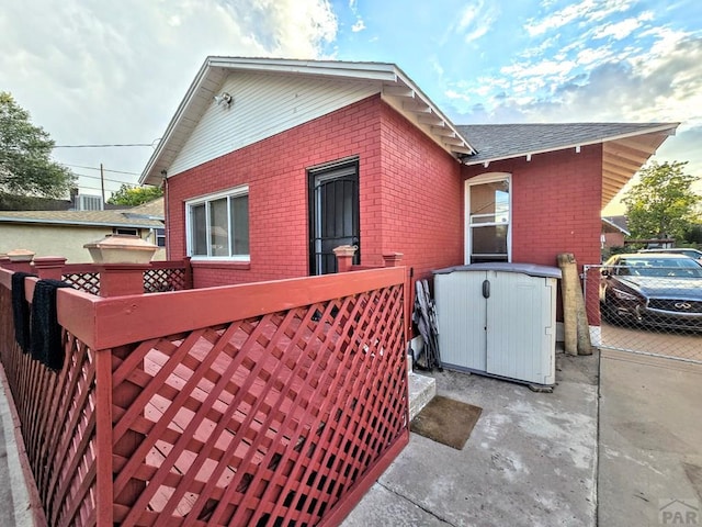 view of side of home with brick siding