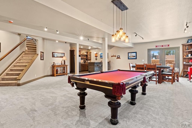 recreation room featuring billiards, carpet flooring, baseboards, french doors, and a bar