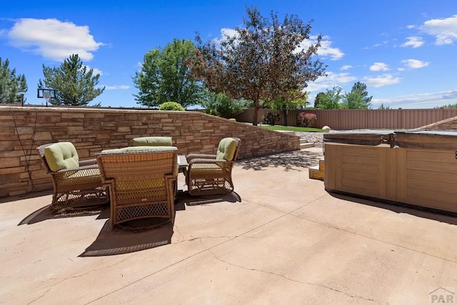 view of patio featuring a fenced backyard and a hot tub