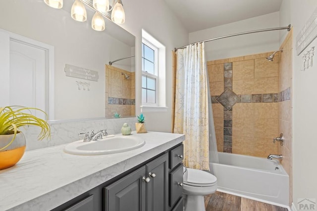 bathroom featuring shower / bath combo, vanity, toilet, and wood finished floors