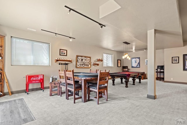 dining room with baseboards, light carpet, and track lighting