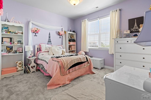 bedroom featuring light carpet and baseboards