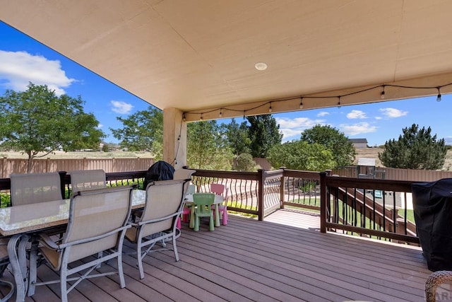 deck with fence and outdoor dining area