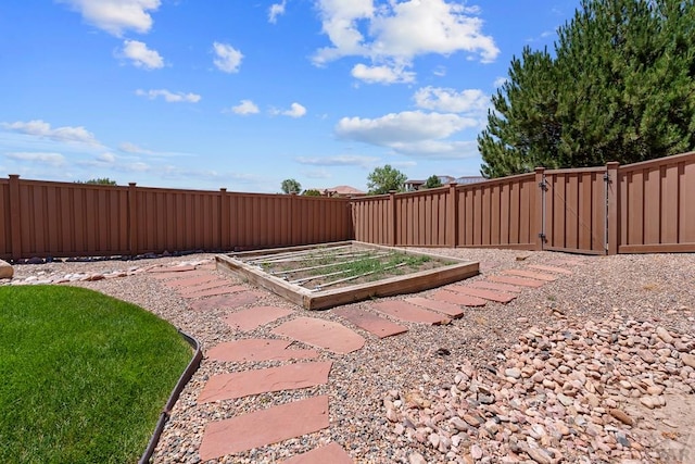 view of yard featuring a fenced backyard and a vegetable garden