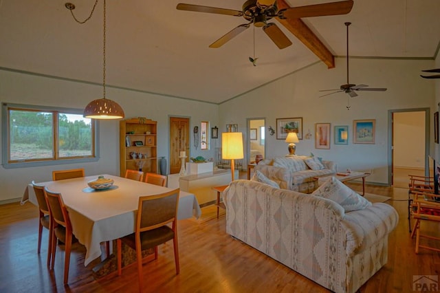 living room with light wood-type flooring and lofted ceiling with beams
