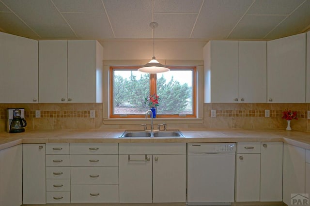 kitchen with dishwasher, a sink, white cabinetry, and decorative light fixtures