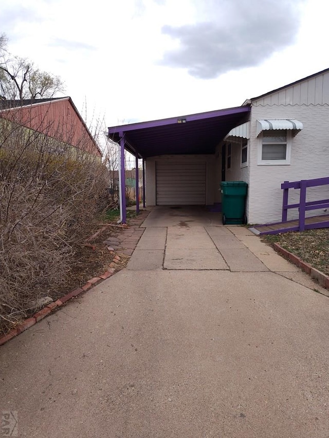726 W Corona Ave, Pueblo, CO 81004 - garage featuring concrete driveway and a carport