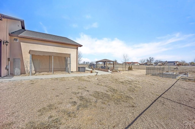 view of yard featuring fence and a gazebo