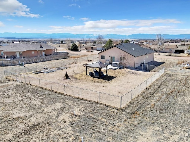 view of yard featuring a residential view, a mountain view, and a gazebo