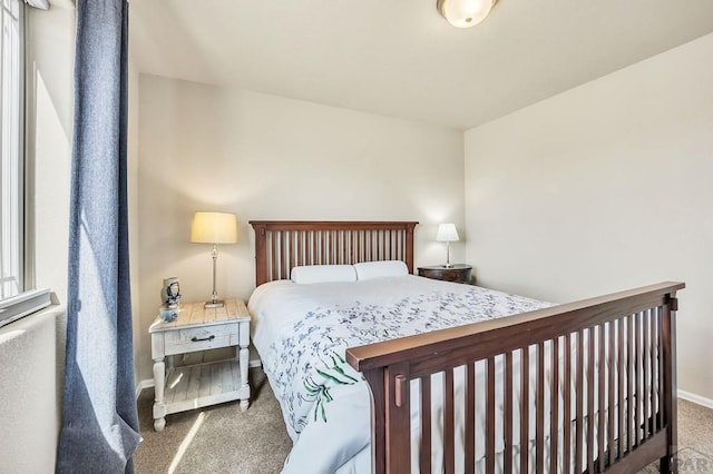 bedroom featuring baseboards and carpet flooring