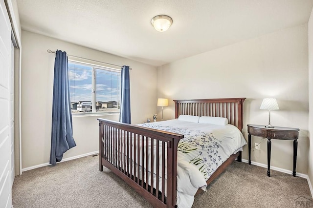 carpeted bedroom with baseboards