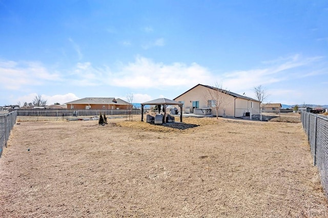 exterior space featuring fence and a gazebo