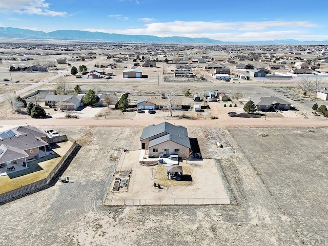 drone / aerial view with a residential view, a mountain view, and a desert view