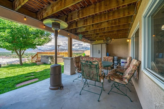 view of patio / terrace with a jacuzzi and outdoor dining space