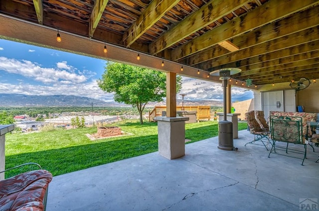 view of patio featuring outdoor dining space and a mountain view