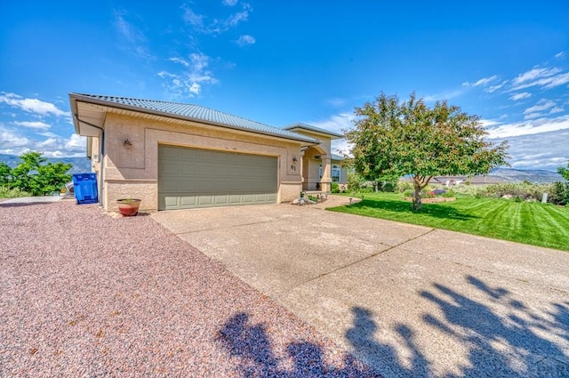 view of front of home featuring a garage, a front yard, driveway, and stucco siding