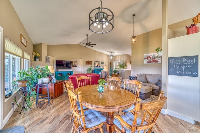 dining room with a ceiling fan, light wood-type flooring, lofted ceiling, and baseboards