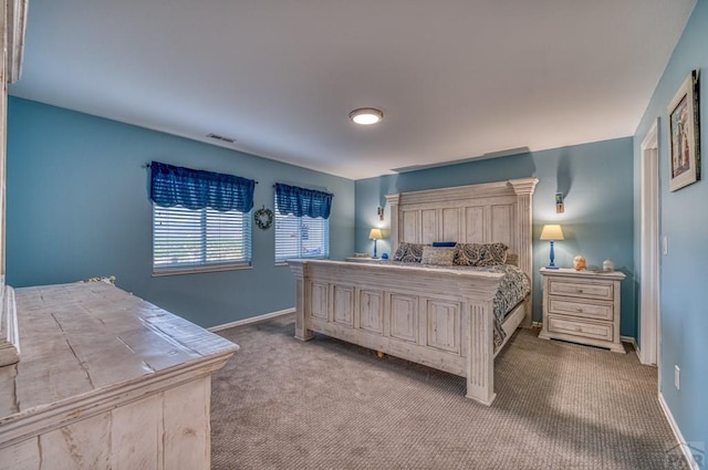 bedroom with visible vents, baseboards, and light colored carpet