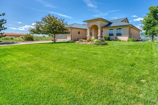 mediterranean / spanish-style home featuring a front lawn and stucco siding