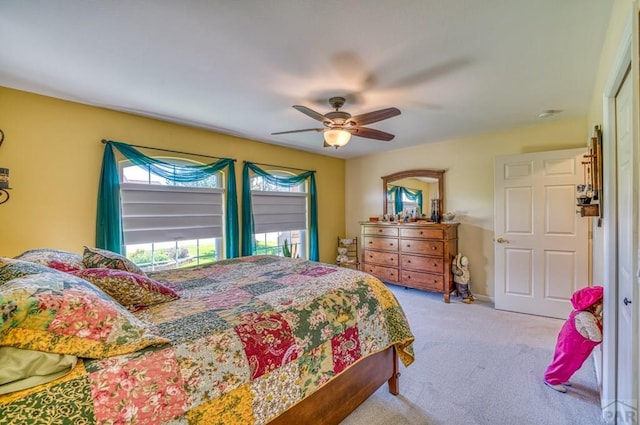 bedroom with light carpet and ceiling fan