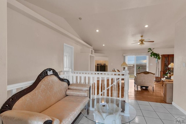 living area with lofted ceiling, recessed lighting, light tile patterned flooring, ceiling fan, and an upstairs landing