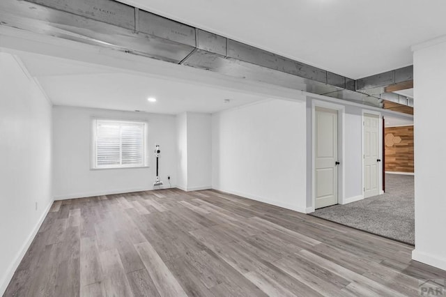 unfurnished room with baseboards, recessed lighting, and light wood-style floors