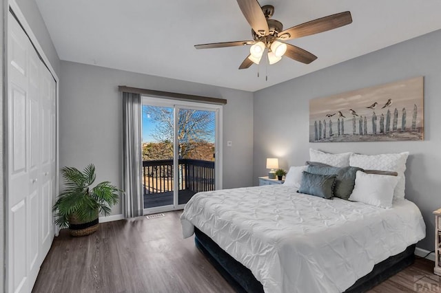 bedroom with access to outside, dark wood-style flooring, and baseboards