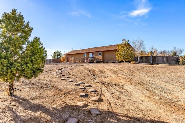 back of house with fence