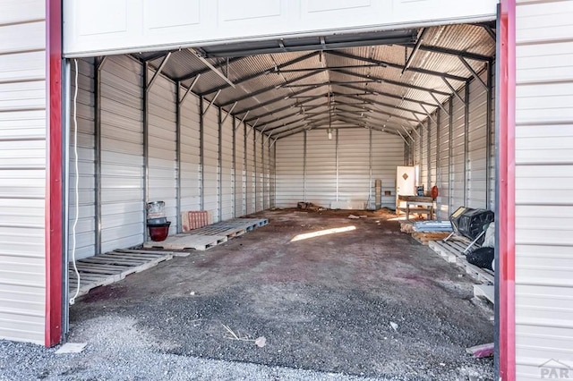 interior space with lofted ceiling and metal wall