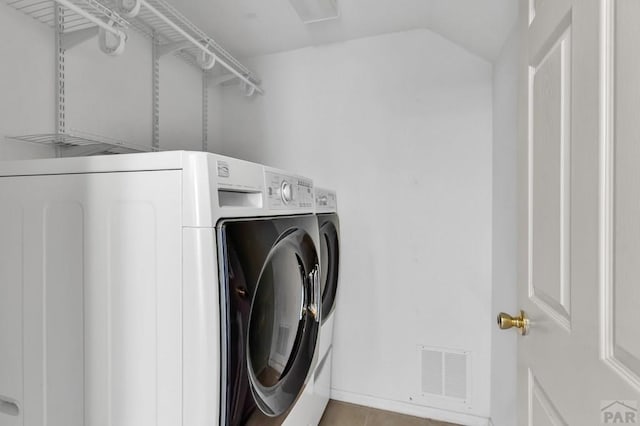 laundry area with laundry area, visible vents, and separate washer and dryer