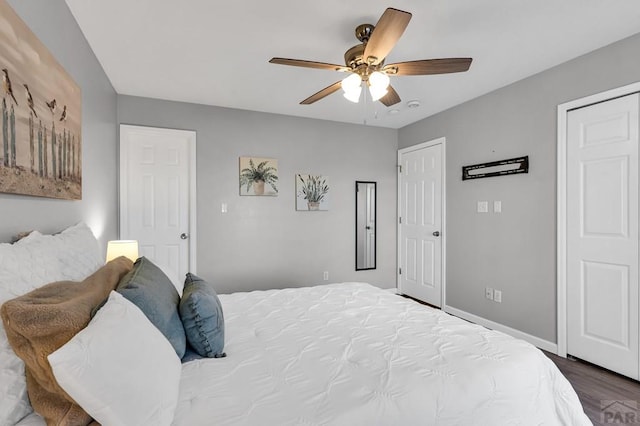 bedroom featuring a ceiling fan, baseboards, and wood finished floors