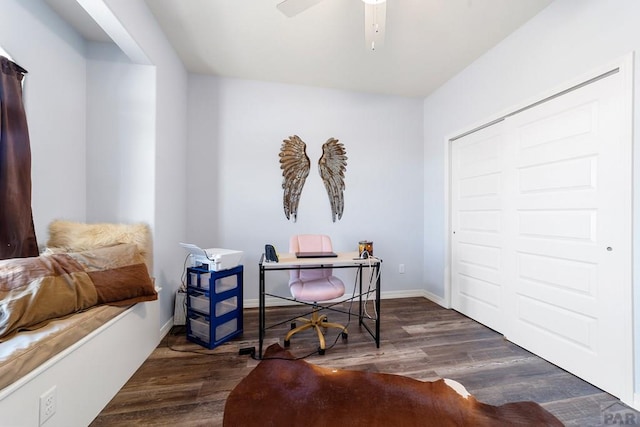 office featuring a ceiling fan, baseboards, and dark wood-type flooring