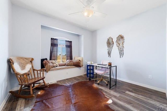 living area with dark wood-style floors, baseboards, and a ceiling fan