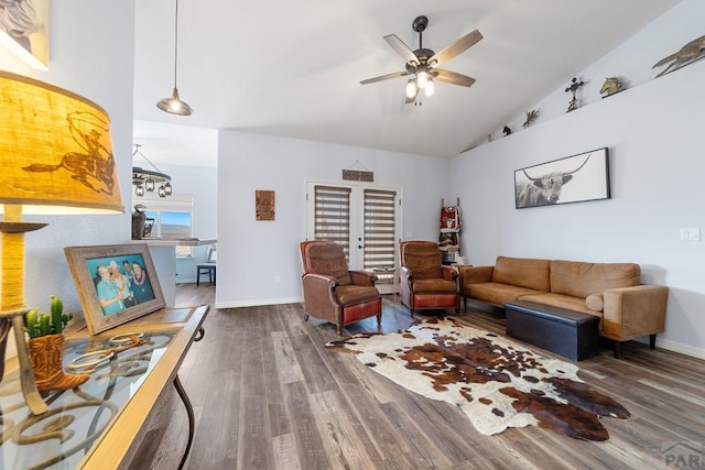 living room featuring dark wood-style floors, ceiling fan, lofted ceiling, and baseboards