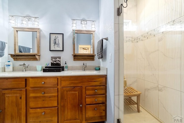 bathroom with double vanity, a sink, and walk in shower