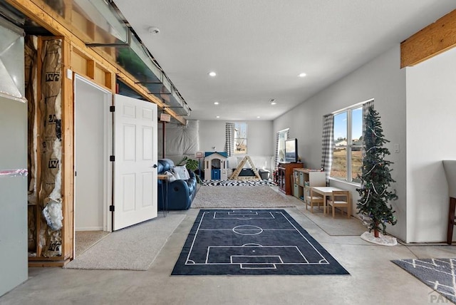 interior space with concrete flooring and recessed lighting