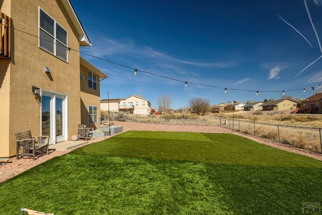 view of yard with fence and a residential view