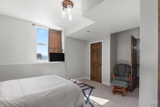 bedroom with carpet floors, baseboards, and visible vents