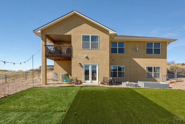 rear view of property with a fenced backyard, a lawn, cooling unit, and stucco siding